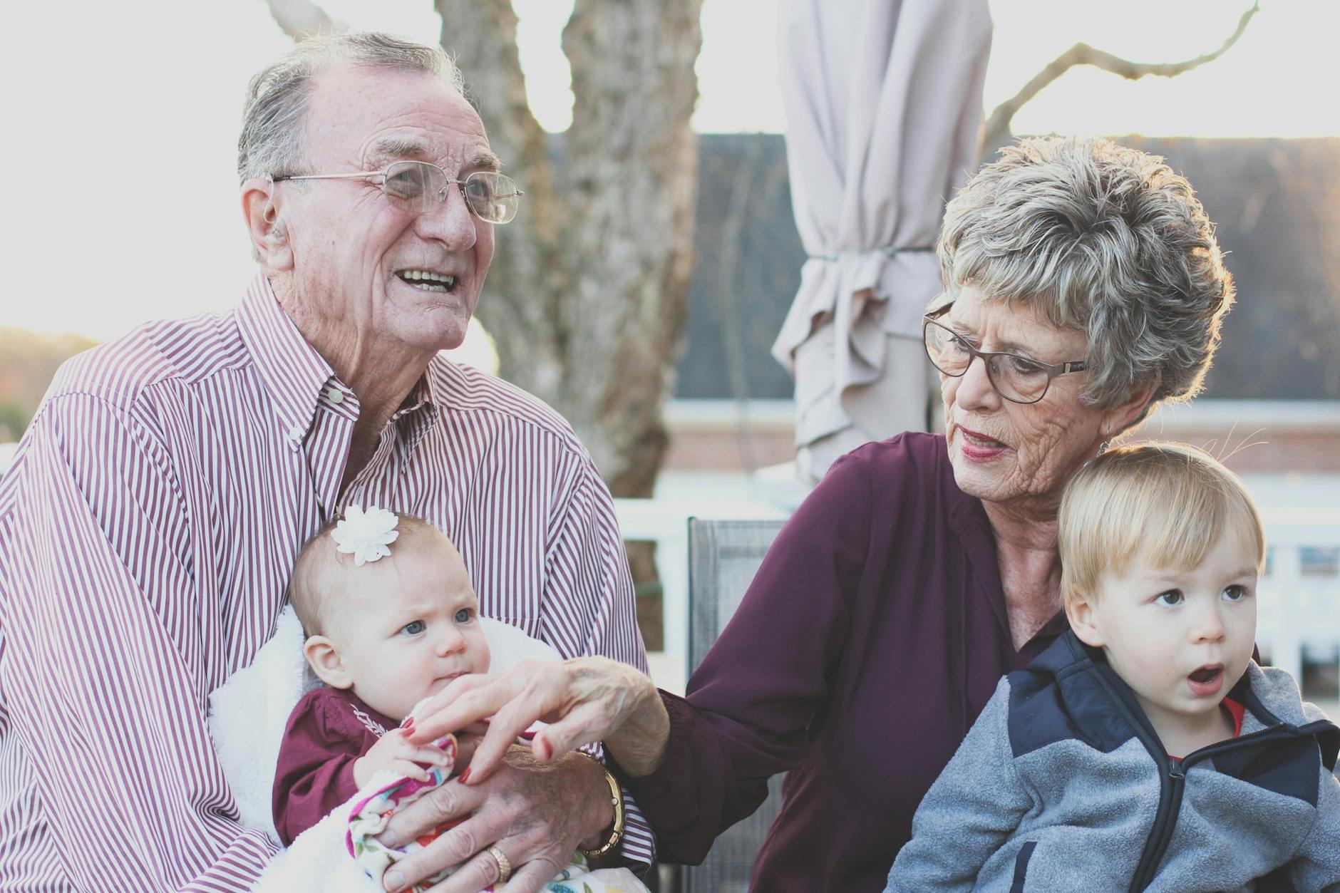 Grandparents smiling with their grandchildren, stepping in to provide love and support when one parent feels unsupported at home.