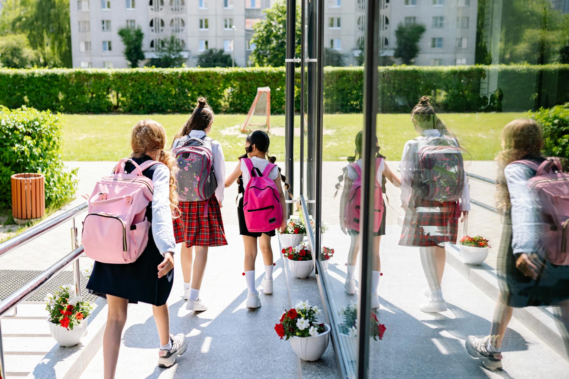Elementary school girls walking to school wearing cute and comfortable back-to-school backpacks.