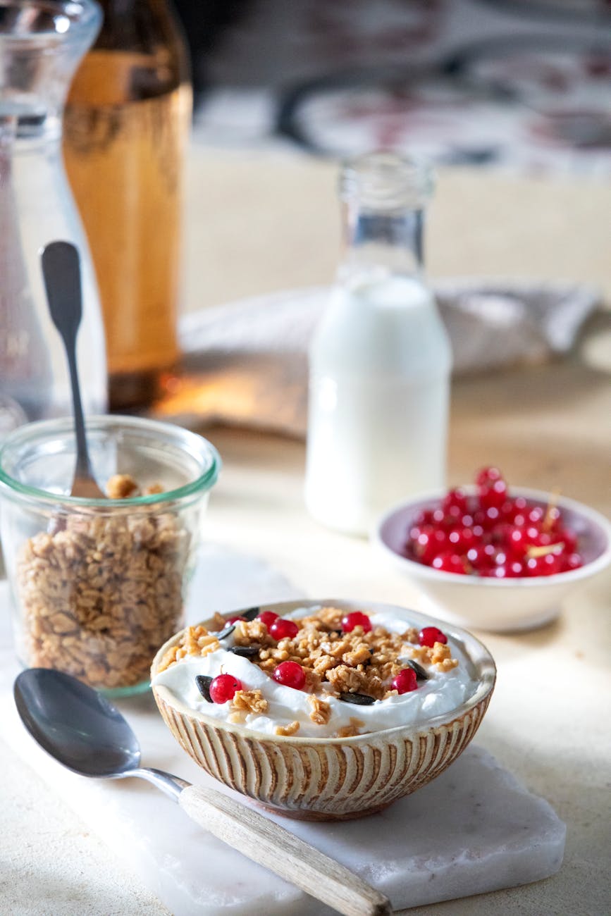 Yogurt parfait cup layered with granola, fresh berries, and honey