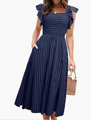 Woman wearing a navy blue flowy midi dress with flutter sleeves, perfect for spring wardrobe