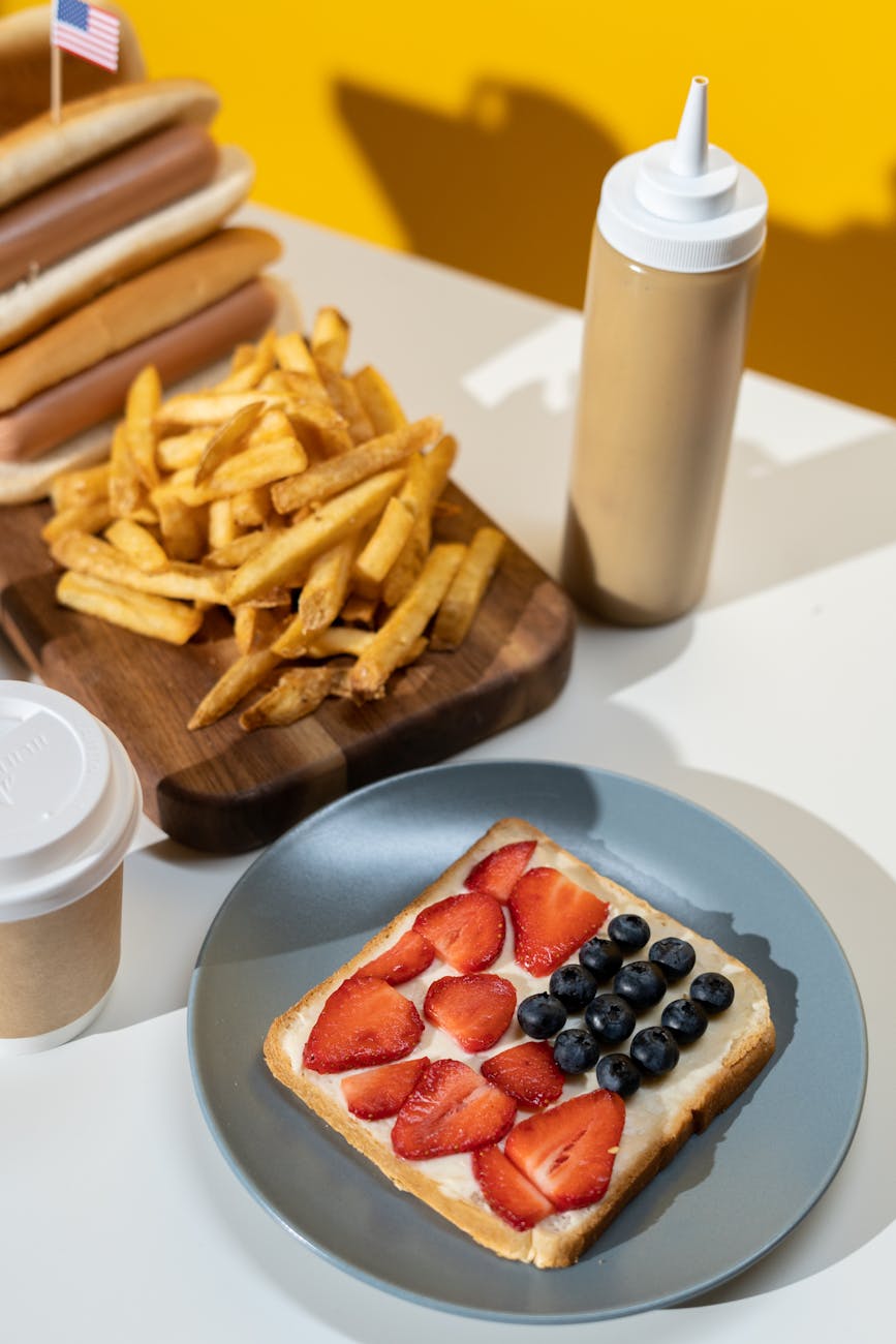 4th of July activities for kids using red white and blue snacks with bread cream strawberries and blueberries